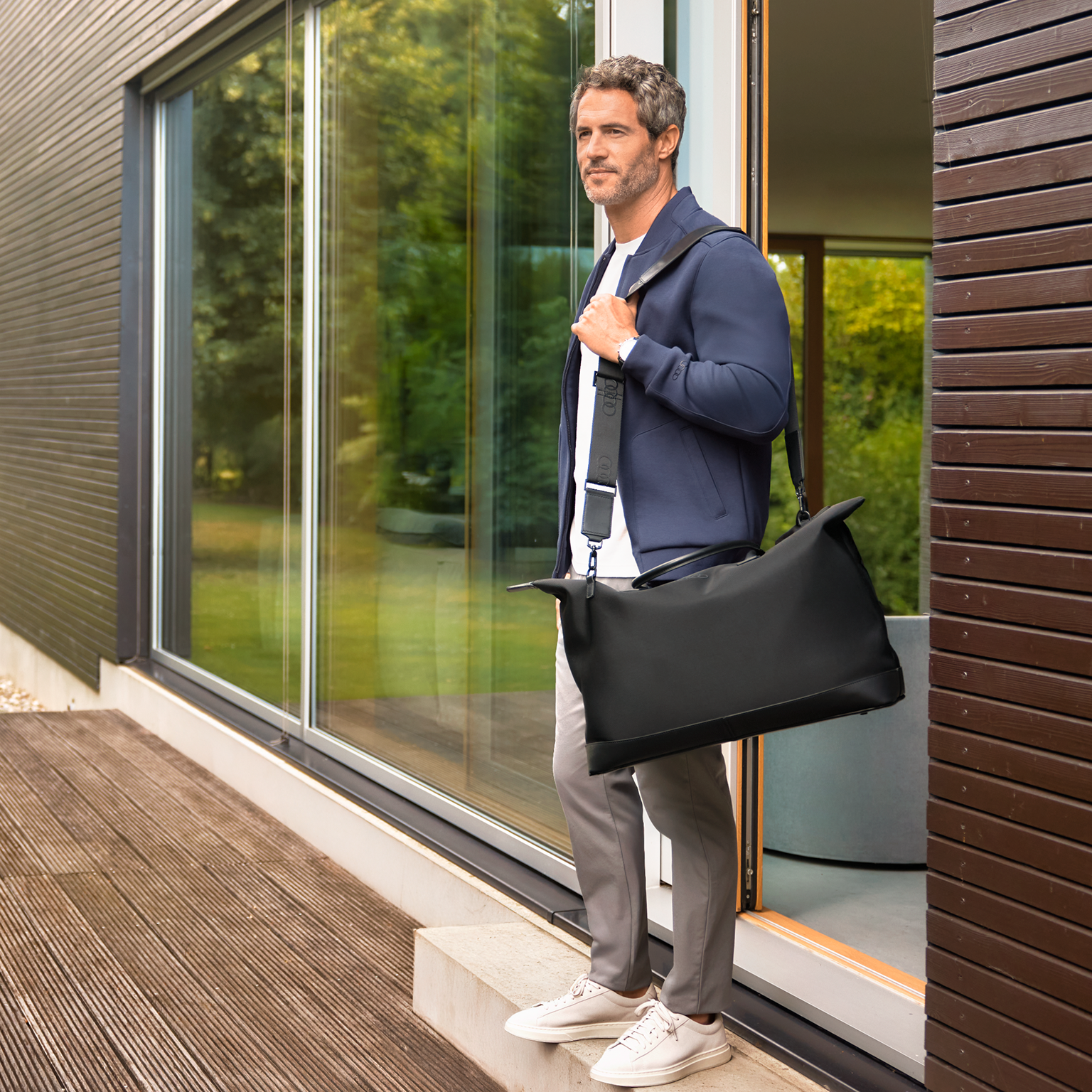 Man wearing a grey Audi collection hoodie.